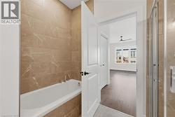 Full bath featuring a bath, a shower stall, and ceiling fan - 