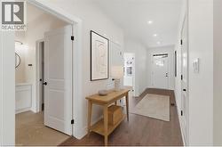 Hallway with light wood-type flooring and recessed lighting - 