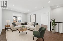 Living area with wood finished floors and recessed lighting - 