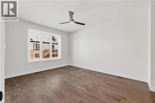Empty room featuring dark wood-style flooring and a ceiling fan - 4 Elgin Street W, Norwich, ON - Indoor Photo Showing Other Room