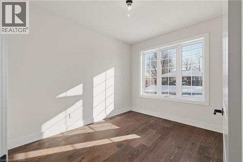 Empty room with dark wood-style flooring and baseboards - 4 Elgin Street W, Norwich, ON - Indoor Photo Showing Other Room