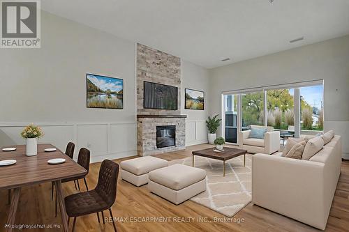 VIRTUALLY STAGED - 006 - 39 Sister Varga Terrace, Hamilton, ON - Indoor Photo Showing Living Room With Fireplace