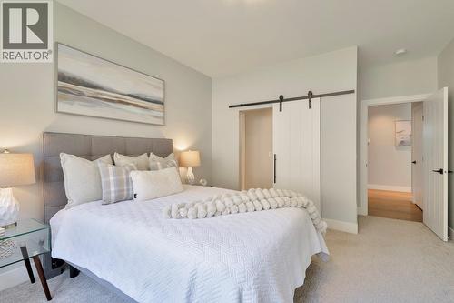 Barn door leads to large walk-in closet & ensuite - 2594 Crown Crest Drive, West Kelowna, BC - Indoor Photo Showing Bedroom