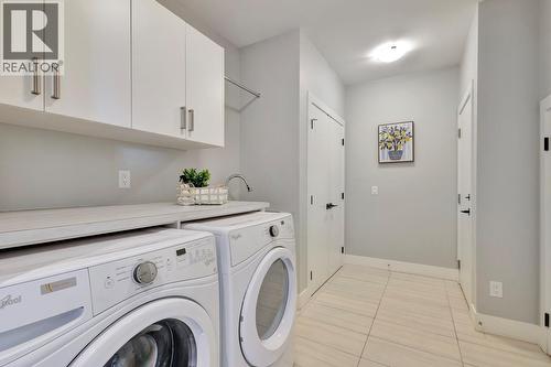 Access to the garage through this room - 2594 Crown Crest Drive, West Kelowna, BC - Indoor Photo Showing Laundry Room