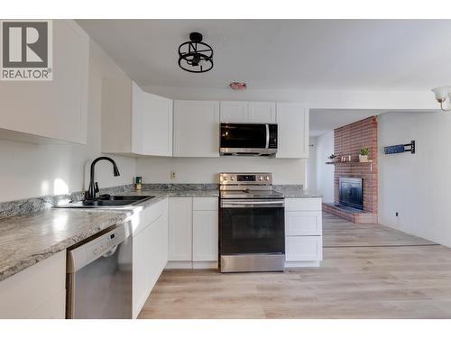 4051 Davis Road, Prince George, BC - Indoor Photo Showing Kitchen With Fireplace With Double Sink