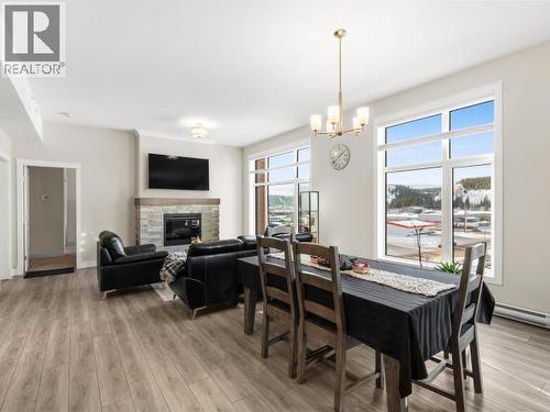 405-36 Waterfront Place, Whitehorse, YT - Indoor Photo Showing Dining Room With Fireplace
