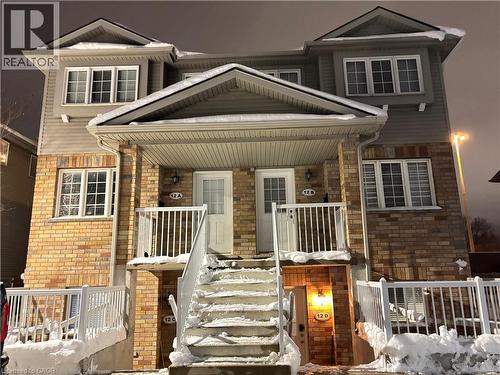 View of front of house with brick siding and a porch - 50 Howe Drive Unit# 12A, Kitchener, ON - Outdoor