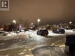 Snow covered parking with a residential view - 