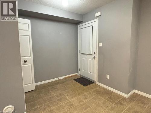 Foyer with baseboards and a textured ceiling - 50 Howe Drive Unit# 12A, Kitchener, ON - Indoor Photo Showing Other Room