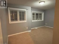 Spare room with light carpet and a textured ceiling - 