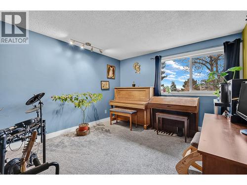 primary bedroom being used as music rm - 715 Leathead Road Unit# 142, Kelowna, BC - Indoor With Fireplace