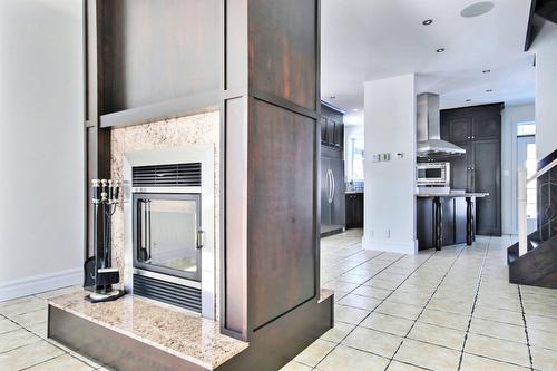 Kitchen - 10 Rue De La Pointe-Aux-Bleuets, Fossambault-Sur-Le-Lac, QC - Indoor Photo Showing Other Room With Fireplace