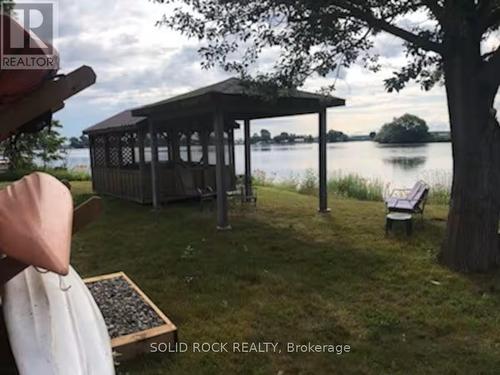 View of kayaks & waterfront screened-in porch - 5 Shoreline Road, Edwardsburgh/Cardinal, ON - Outdoor With Body Of Water