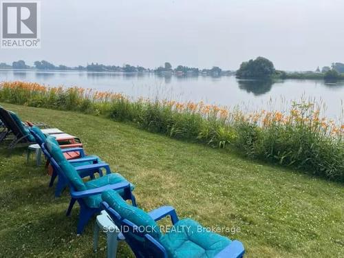 Adirondack chairs by waterfront - 5 Shoreline Road, Edwardsburgh/Cardinal, ON - Outdoor With Body Of Water With View