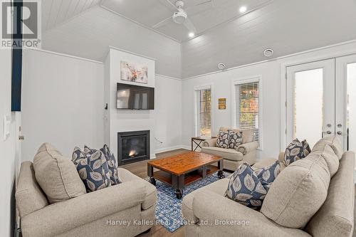 Living room with fireplace & walkout to rear yard - 15 - 2054 Peninsula Road, Muskoka Lakes (Medora), ON - Indoor Photo Showing Living Room With Fireplace
