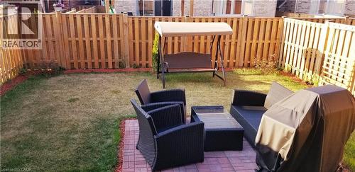 Fenced backyard featuring grilling area and a patio - 118 Steeplechase Way, Waterloo, ON - Outdoor With Exterior