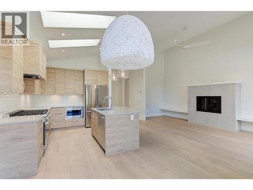 Open concept living room with electric fireplace - 761 Barnaby Road, Kelowna, BC - Indoor Photo Showing Kitchen