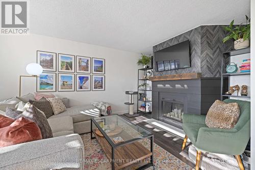901 - 700 Dynes Road, Burlington, ON - Indoor Photo Showing Living Room With Fireplace