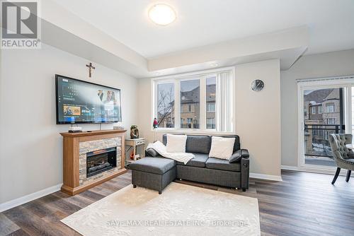 213 - 3075 Thomas Street, Mississauga, ON - Indoor Photo Showing Living Room With Fireplace