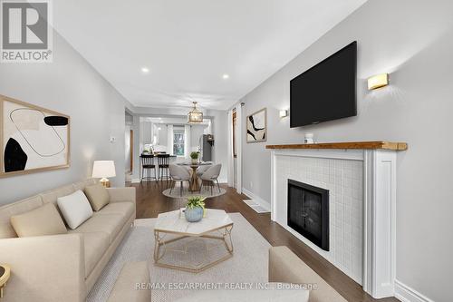 VIRTUALLY STAGED - 266 Wexford Avenue S, Hamilton, ON - Indoor Photo Showing Living Room With Fireplace