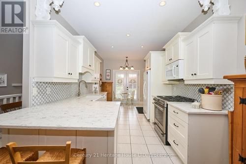 View of the French doors to the backyard from kit. - 32 Sunrise Court, Fort Erie (Ridgeway), ON - Indoor Photo Showing Kitchen