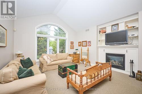 LR with large window and fireplace - 32 Sunrise Court, Fort Erie (Ridgeway), ON - Indoor Photo Showing Living Room With Fireplace