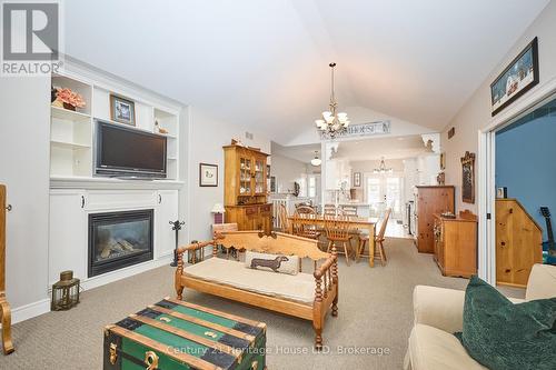 Living room with fireplace and vaulted ceiling - 32 Sunrise Court, Fort Erie (Ridgeway), ON - Indoor Photo Showing Living Room With Fireplace