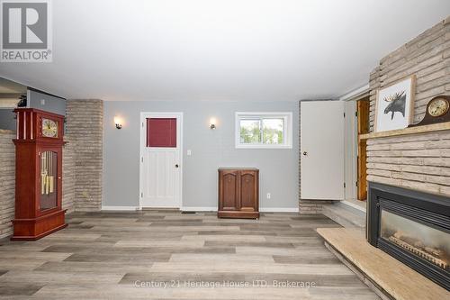 Rec room on the lower level with door & fireplace - 15 Malkin Avenue, Fort Erie (Lakeshore), ON - Indoor With Fireplace