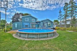 Backyard view of property and above-ground pool - 