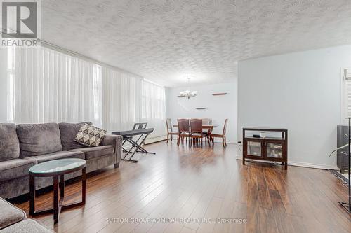 View of living and dining from the bedroom - 209 - 2245 Eglinton Avenue E, Toronto, ON - Indoor Photo Showing Living Room