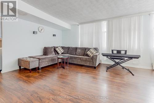 Corner comfortable set-up of your L-shaped couch - 209 - 2245 Eglinton Avenue E, Toronto, ON - Indoor Photo Showing Living Room
