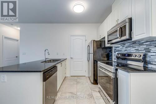 kitchen - 309 - 1360 Costigan Road, Milton, ON - Indoor Photo Showing Kitchen With Stainless Steel Kitchen With Double Sink