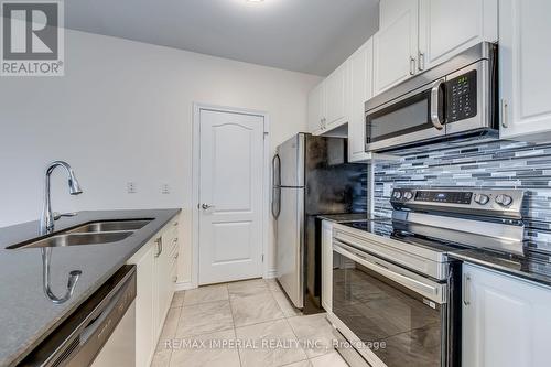 kitchen - 309 - 1360 Costigan Road, Milton, ON - Indoor Photo Showing Kitchen With Stainless Steel Kitchen With Double Sink