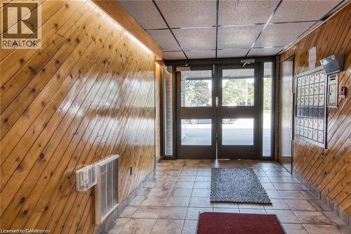 Doorway featuring wood walls, a drop ceiling, and tile patterned flooring - 71 Vanier Drive Unit# 211, Kitchener, ON - Indoor Photo Showing Other Room