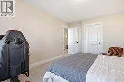 Bedroom with light carpet and baseboards - 