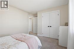 Bedroom with light carpet and a closet - 