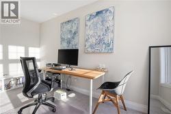Office space with light colored carpet and baseboards - 