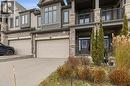View of front facade featuring brick siding, driveway, a balcony, and a garage - 592 Mayapple Street, Waterloo, ON  - Outdoor With Facade 
