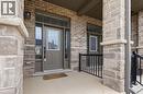 Property entrance featuring covered porch, stone siding, and brick siding - 592 Mayapple Street, Waterloo, ON  - Outdoor With Exterior 