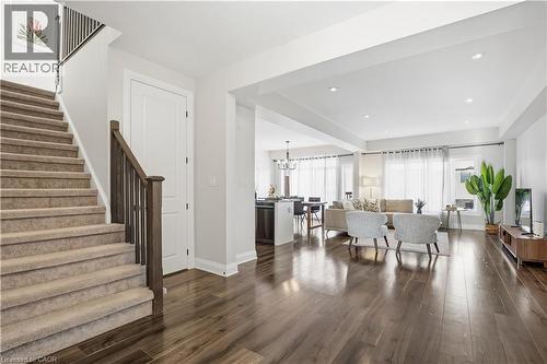 Entryway featuring stairway, dark wood-type flooring, a chandelier, and recessed lighting - 592 Mayapple Street, Waterloo, ON - Indoor