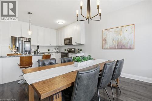 Dining space with dark wood-type flooring and a chandelier - 592 Mayapple Street, Waterloo, ON - Indoor Photo Showing Other Room