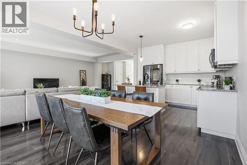 Dining space featuring dark wood-style flooring and a chandelier - 592 Mayapple Street, Waterloo, ON - Indoor