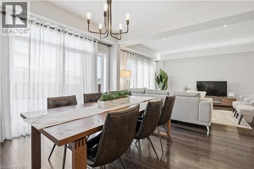 Dining area with dark wood-type flooring - 592 Mayapple Street, Waterloo, ON - Indoor Photo Showing Dining Room