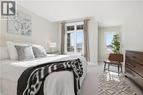 Bedroom with light carpet and baseboards - 592 Mayapple Street, Waterloo, ON - Indoor Photo Showing Bedroom