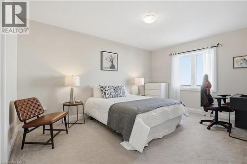 Carpeted bedroom featuring baseboards and a desk - 592 Mayapple Street, Waterloo, ON - Indoor Photo Showing Bedroom