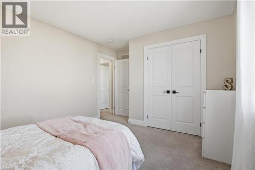 Bedroom with light carpet and a closet - 592 Mayapple Street, Waterloo, ON - Indoor Photo Showing Bedroom
