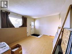 Entryway with a textured ceiling and light wood-style flooring - 
