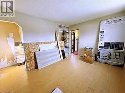 Living room featuring a textured ceiling, wood finished floors, and a ceiling fan - 