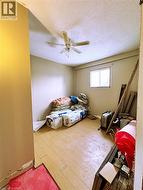 Unfurnished bedroom with ceiling fan, wood-type flooring, and a textured ceiling - 