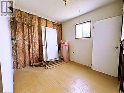 Empty room with a textured ceiling and light wood finished floors - 